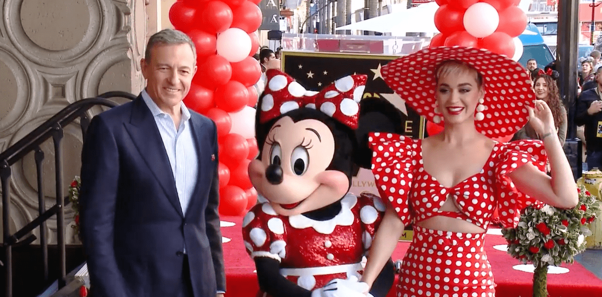 Bob Iger stands with Minnie Mouse at a Disney event