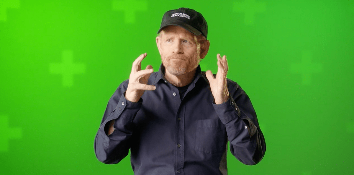 Ron Howard sits in front of a green screen.