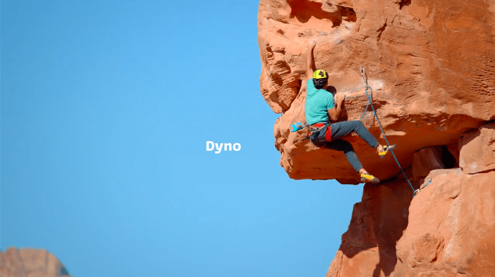 Image of Tommy Caldwell lead climbing outdoors having just completed a dyno (dynamic) move