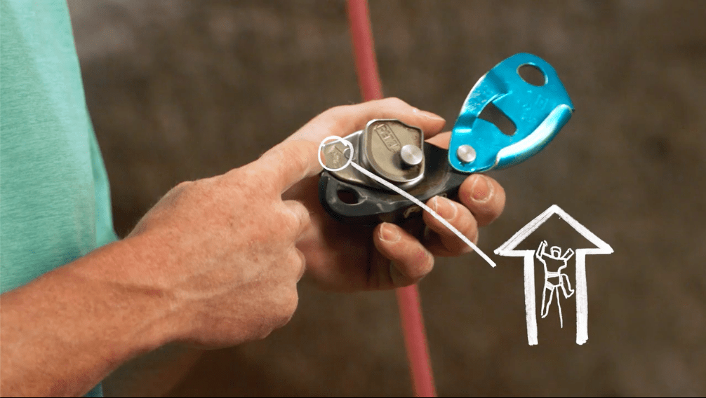 Image of Tommy Caldwell showing course takers how to use and load a GriGri autolock belay device