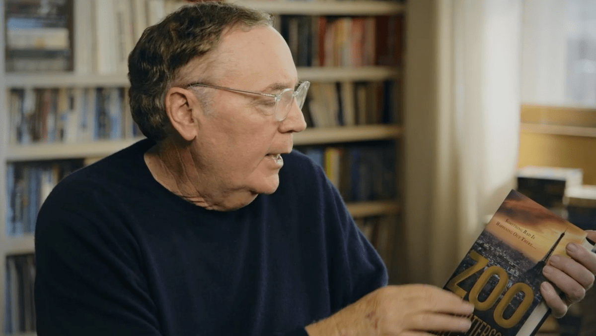 James Patterson holding his novel, Zoo