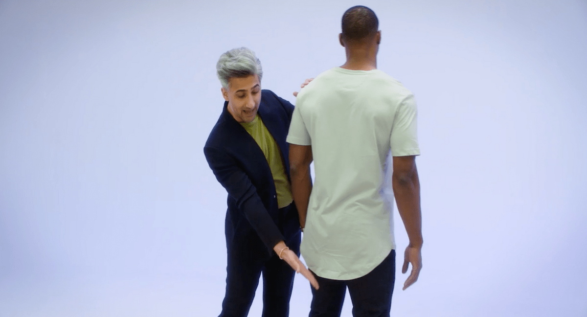 Tan France showcasing a model's shirt that's entirely too long for his body